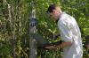 Edward Entsminger, wildlife and fisheries science graduate student, checks trail cameras to monitor wildlife presence and spreads native wildflower seeds. (Photo by Kat Lawrence)