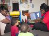 From left, Brenda Wright, owner of Heavenly Hearts Learning Center in Nesbit, joins Schmaya Miller, Kingston Jenkins and Ken'Narius Johnson to listen as LaLetrice Fletcher, field technical assistant with the Nurturing Homes Initiative, reads them a book. (Photo by MSU Extension Service/Alicia Barnes)