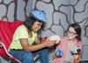 Mississippi State University secondary-education teacher candidate Ann Claire Blakely, right, teaches Studio School student LaGlotrice Jordan in the Body Walk brain room in June 2013. The Studio School hosts Body Walk with help from the MSU Extension Service and the MSU Center for the Advancement of Service-Learning. (Submitted photo)