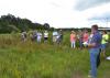 Brett Rushing, an assistant professor at Mississippi State University, discusses various planting and maintenance methods used on four native wildflower plots at the MSU Coastal Plains Branch Experiment Station in Newton on July 13, 2017, during the Wildflower Field Day. (Photo by MSU Extension Service/Susan Collins-Smith)