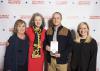 Four people pose for a photo with the award presented to the Mississippi State University Extension Service for its support of the Wildflower Trails of Mississippi Project.