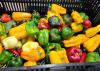A basket holds an assortment of red, yellow and green peppers.