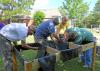 From left, Lamar County Extension Agent Ross Sadler, Pine Belt Master Gardener Paul Cavanaugh, Lamar County Technical Center teacher and volunteer Ken McCoy and Pine Belt Master Gardener intern Cecil Chambliss prepare a handicapped-accessible raised bed for plants. The group built two beds for residents of The Windham House of Hattiesburg, an assisted-living facility for seniors on May 28 and will return monthly to help with the beds and teach workshops. (Photo by MSU Ag Communications/Susan Collins-Smith)