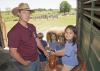 Mississippi State University animal and dairy science major Jacob McCarty of Summit, left, shows Starkville Academy student Abby Edwards how to sit properly in a saddle during Afternoon on the Farm May 1, 2015. The activities took place at the H.H. Leveck Animal Research Center at MSU, commonly called the South Farm, in Starkville. (Photo by MSU Extension Service/Kat Lawrence)