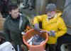 Post-doctoral student Dan O'Keefe, left, works with Mississippi State University fisheries biologist Don Jackson to tag young, university-raised catfish released in a project restoring hurricane-ravaged south Mississippi waterways in 2006. Jackson recently received a conservation award from the Mississippi chapter of the American Fisheries Society. (Photo by MSU Office of University Relations/Russ Houston)