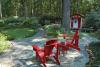 Red can be a difficult color to use in gardens, and the secret to its success sometimes lies in using it as an accent. The first thing that catches the eye in this outdoor room is the bright red Adirondack chairs. A short walk away is an idyllic children's play house of the same color. (Photo by Norman Winter)