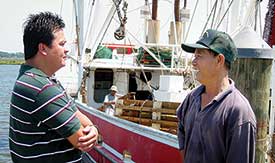 Two men talking at the docks.