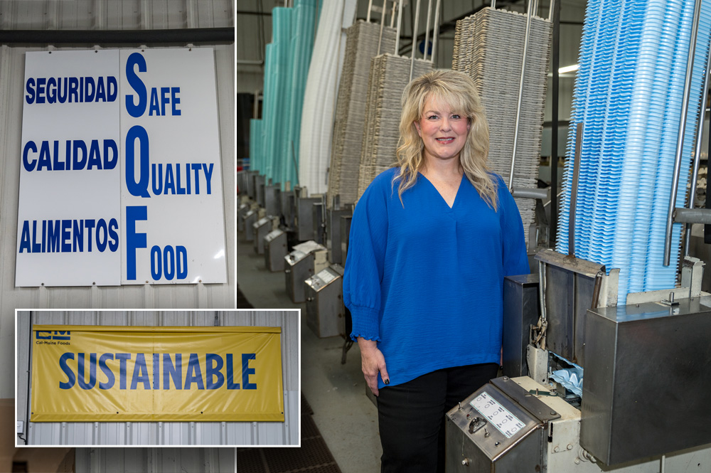 A woman standing beside pallets of egg crates with one signs listing Safe, Quality Foods and another sign listing Sustainable on the left.
