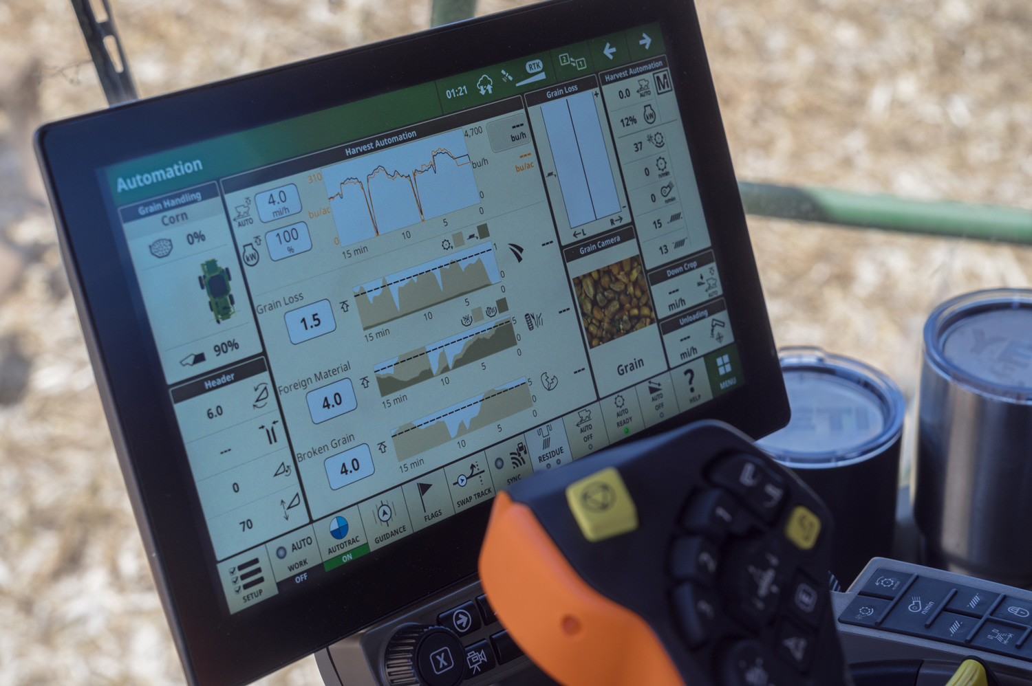 Lit combine screen showing corn harvest information.
