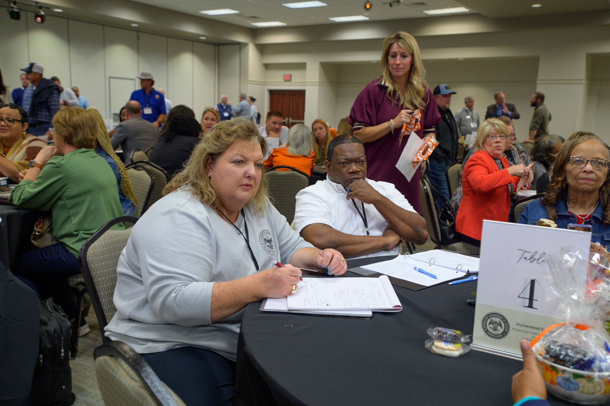 Four people listening in a conference room.