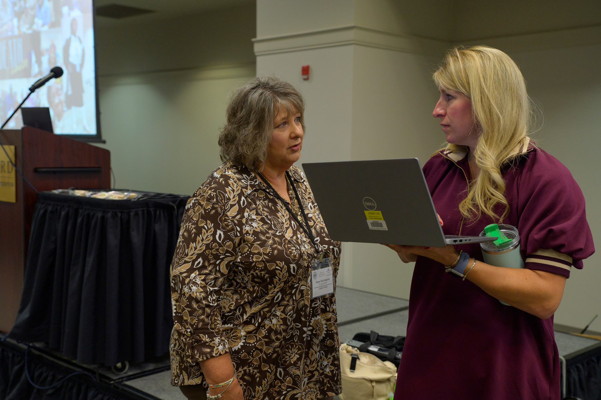 Two people talking in a conference room.