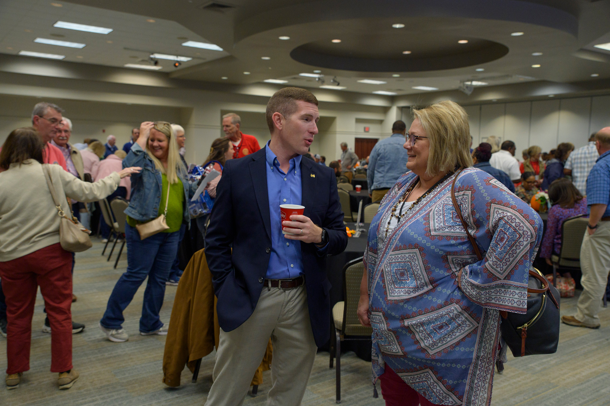 Two people talking in a conference room.