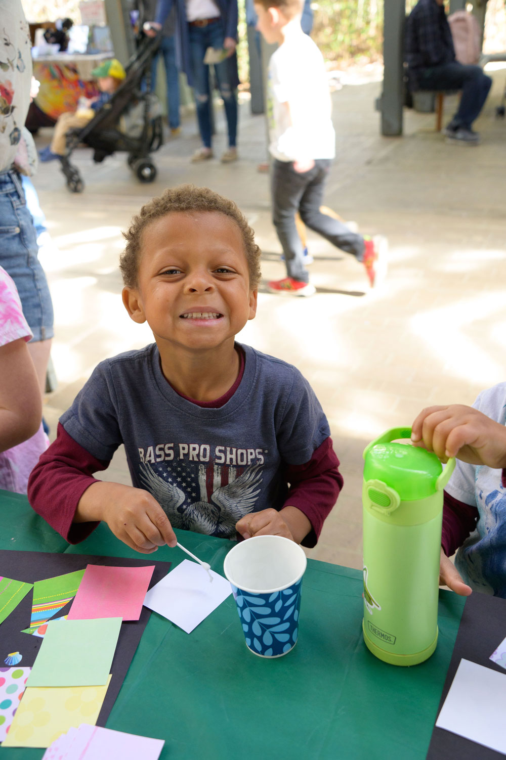 A smiling child creating art.
