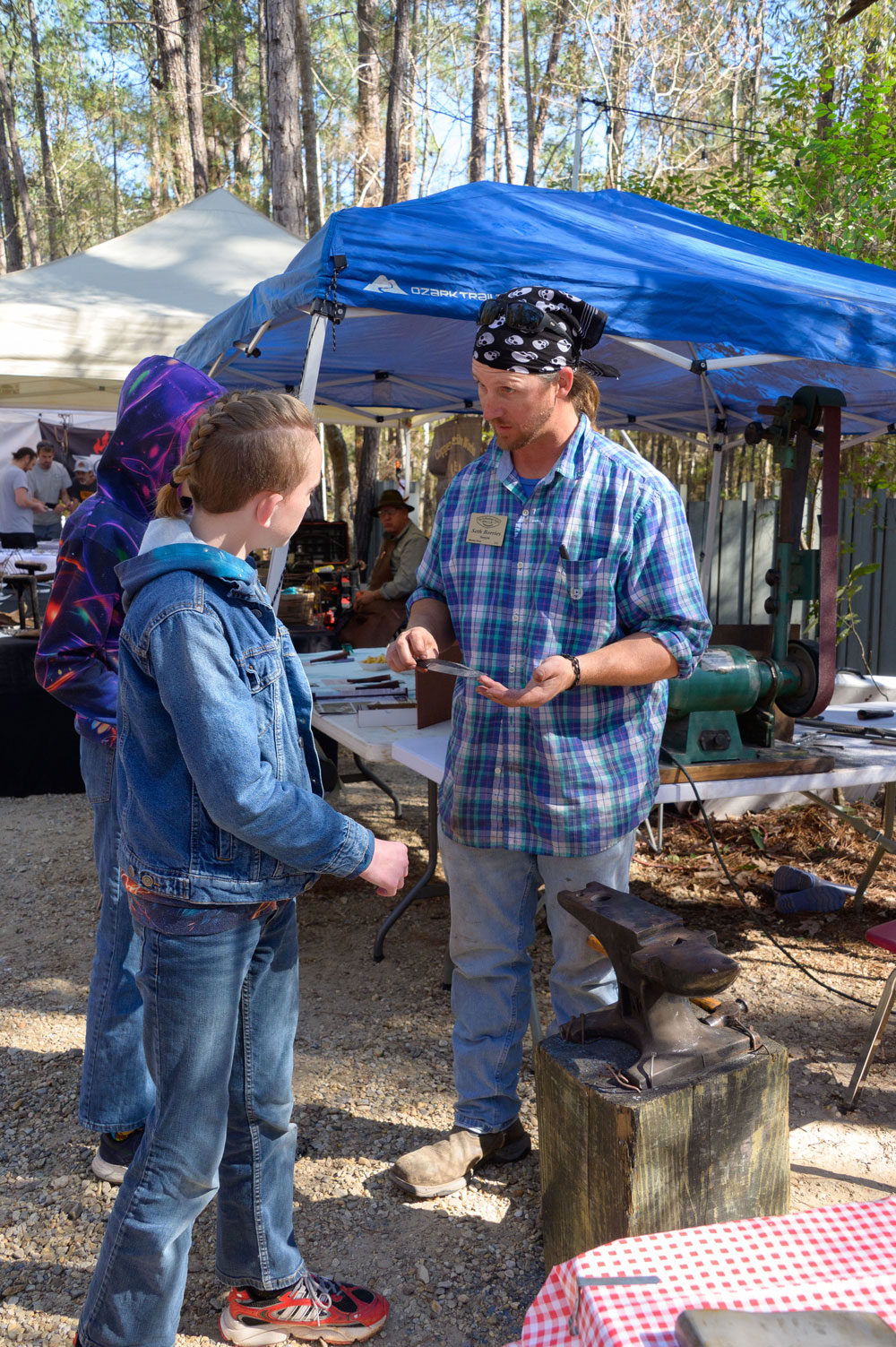 A child watches a person explaining knife safety.