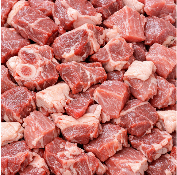Close-up of cubed cuts of raw sheep and goat meat.