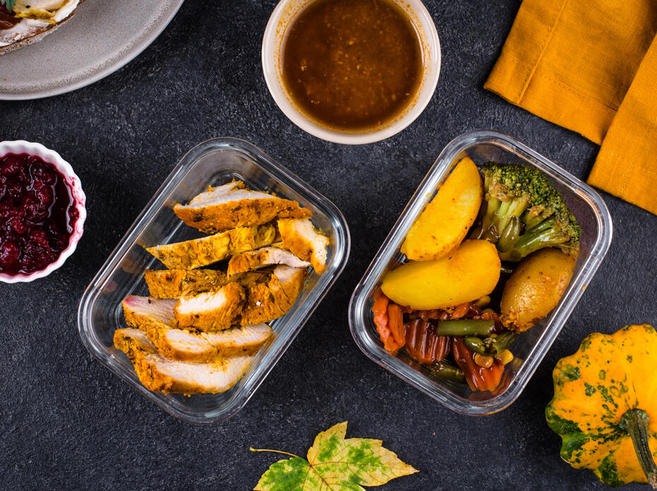 To-go containers of food and sauces on a table