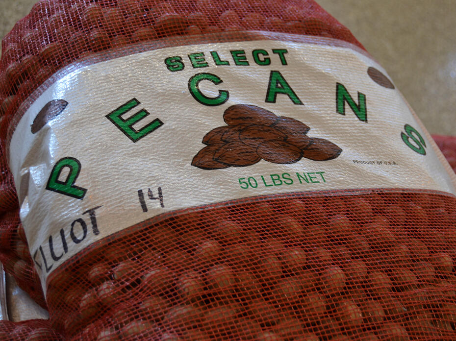 A closeup of a label on a 50-pound bag of in-shell pecans.