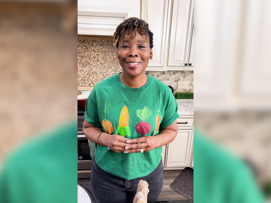 A woman stands in a kitchen.