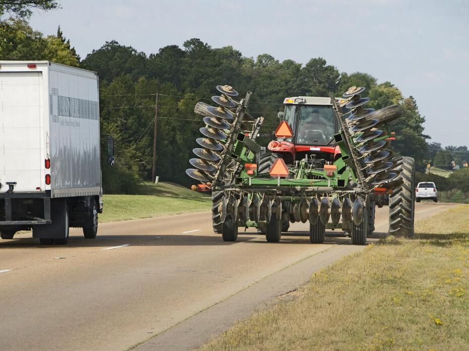 Combine driving on the road.