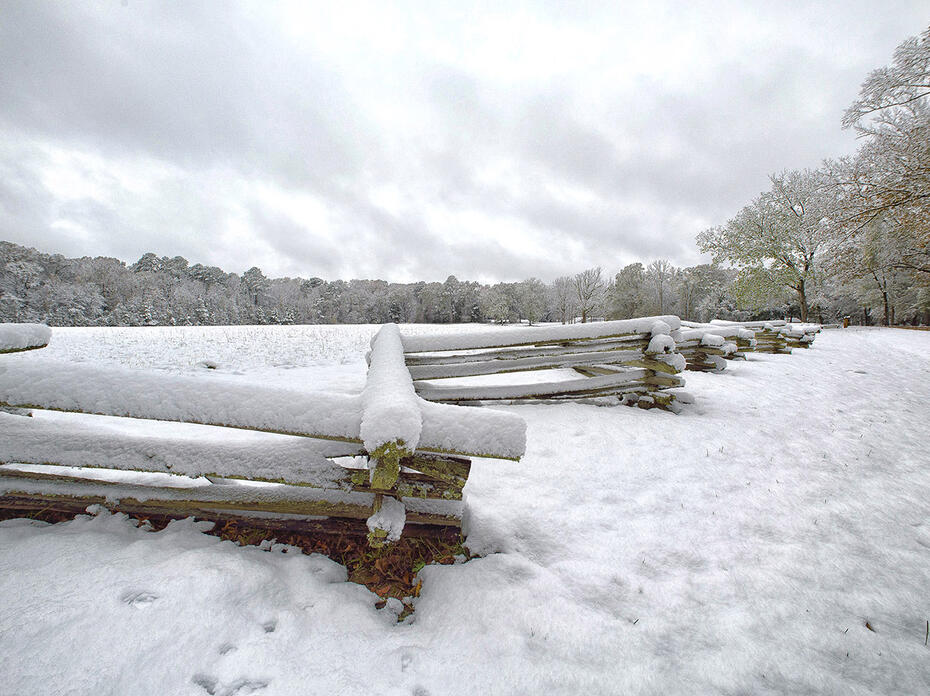 Snow covers a split-rail fence and trees near Mount Locust on the Natchez Trace in Jefferson County, Mississippi on Dec. 8, 2017.