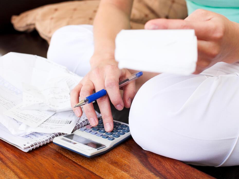 Closeup of a woman budgeting personal finances.