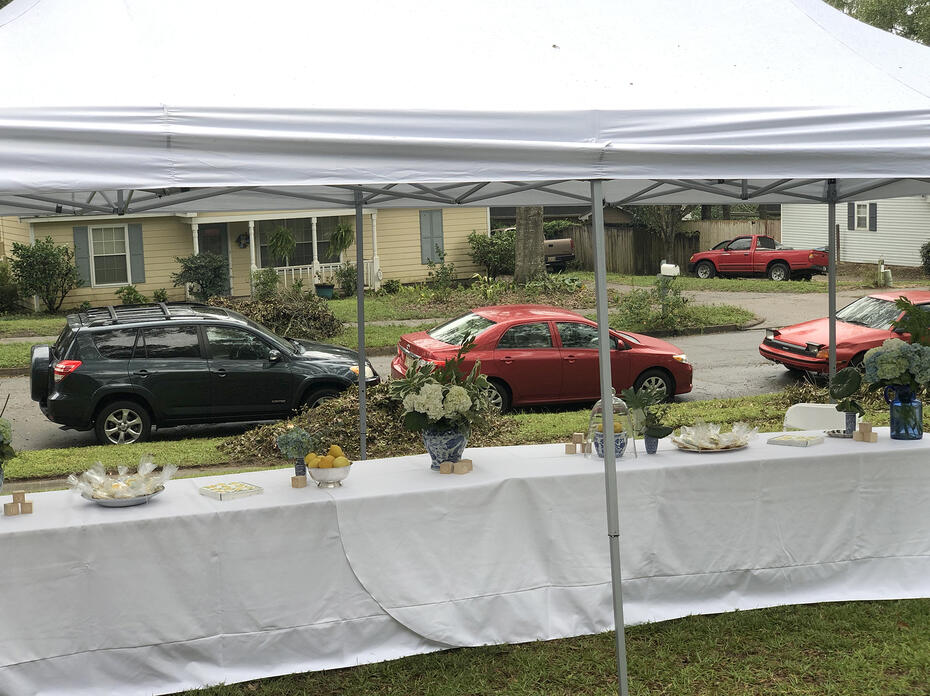 From inside a tent, cars can be seen lined up on the street.