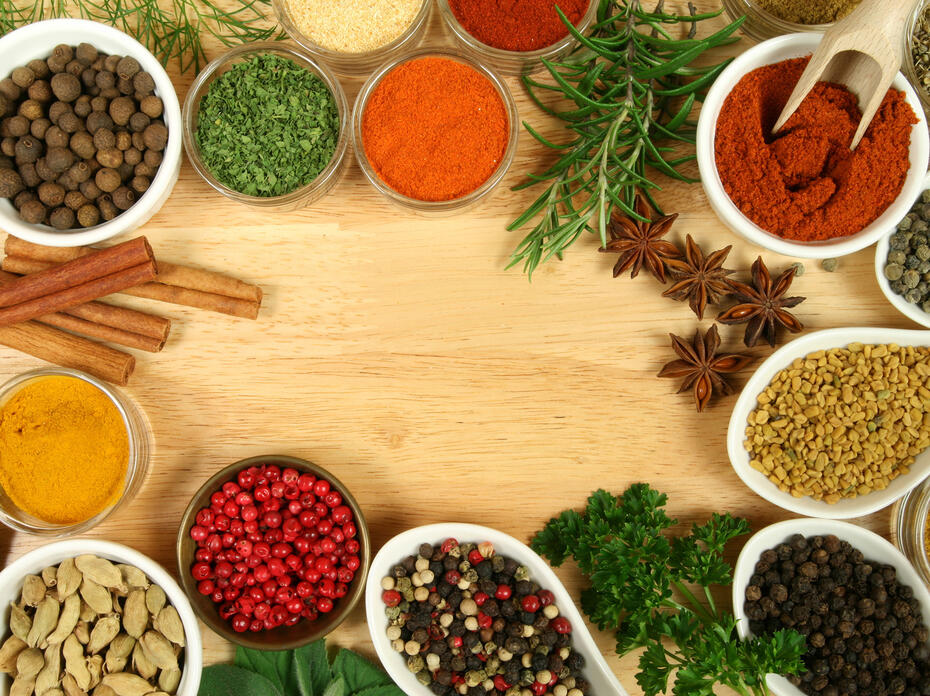 Closeup of herbs and spices on a cutting board.