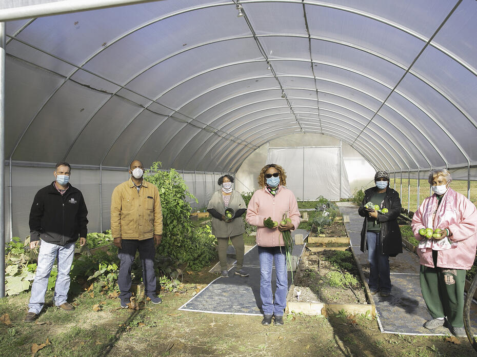 People stand in a garden.