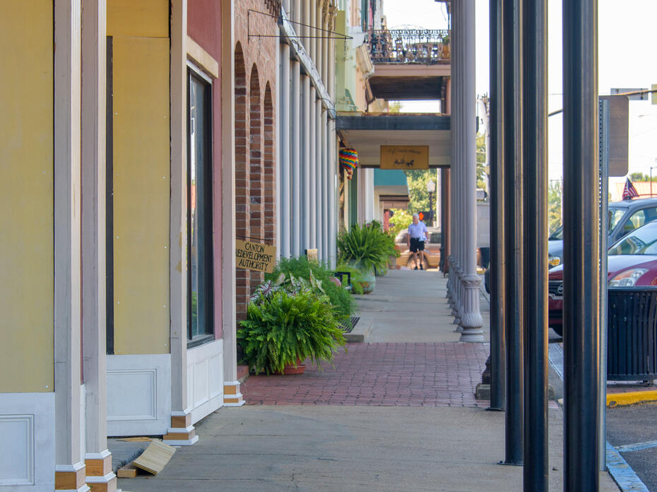 A view down a covered downtown sidewalk.