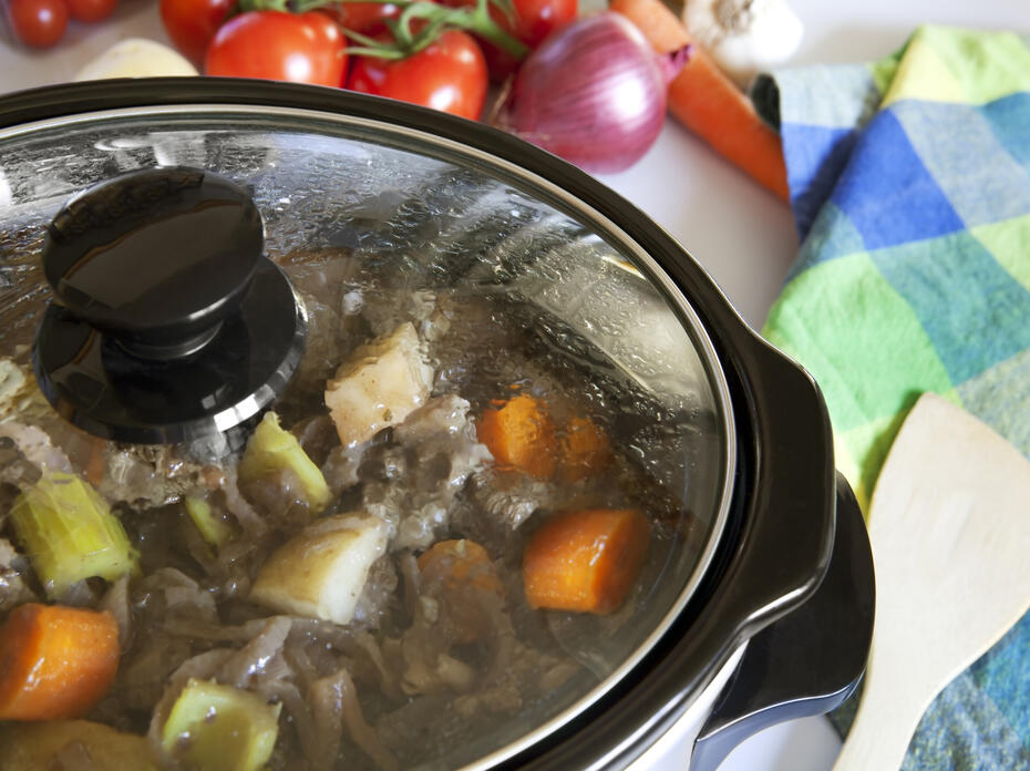 A slow cooker filled with food.