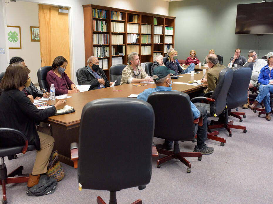 A group of people sitting around a table.