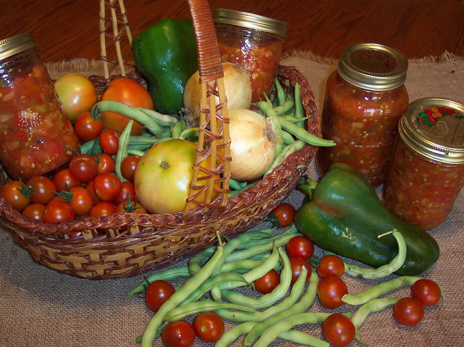 Canned salsa in a basket with other produce