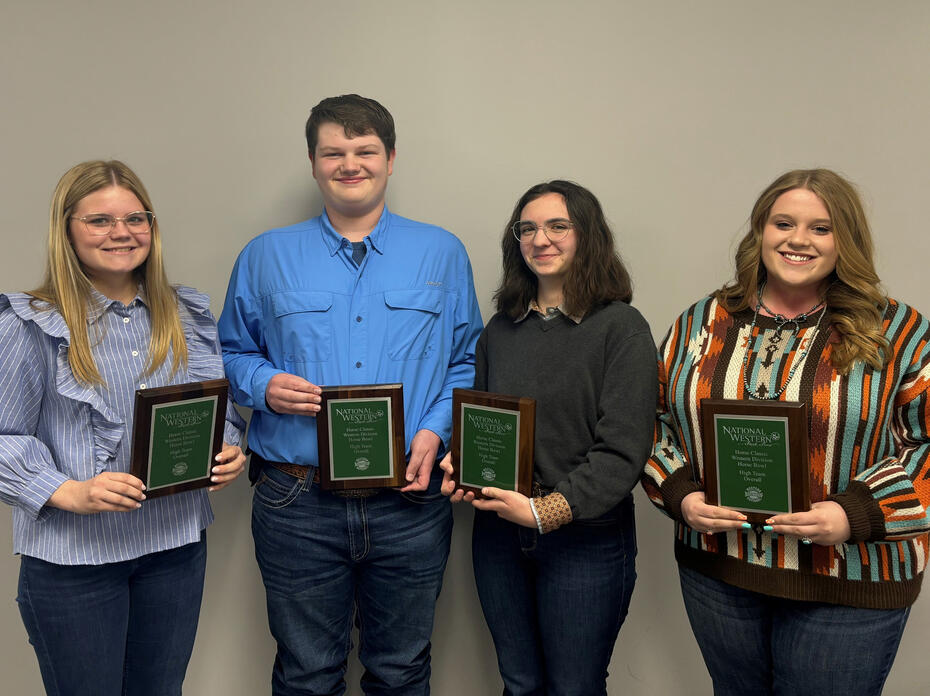 Four teenagers hold plaques.