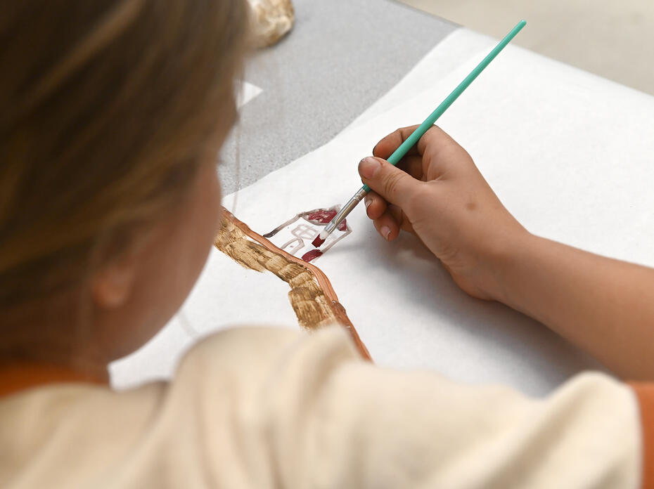 A child paints a picture.