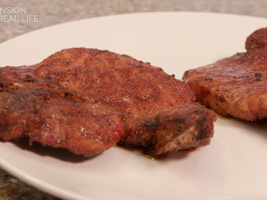 Cooked pork chops on a plate.