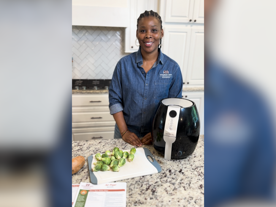 A woman in a kitchen with an air fryer.