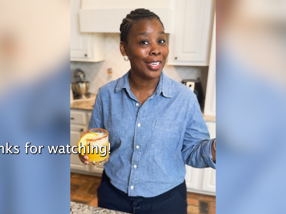 A woman stands in a kitchen.