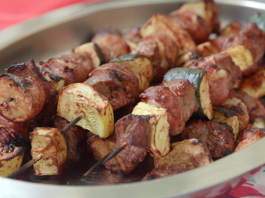 Beef and potato kabobs on a stainless steel platter