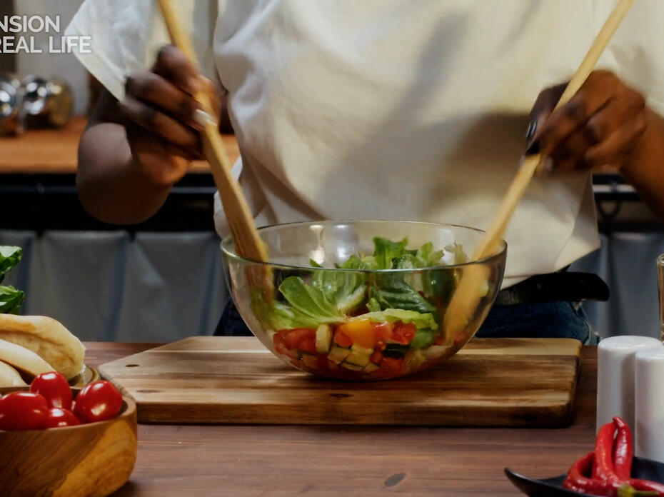 Woman tossing salad