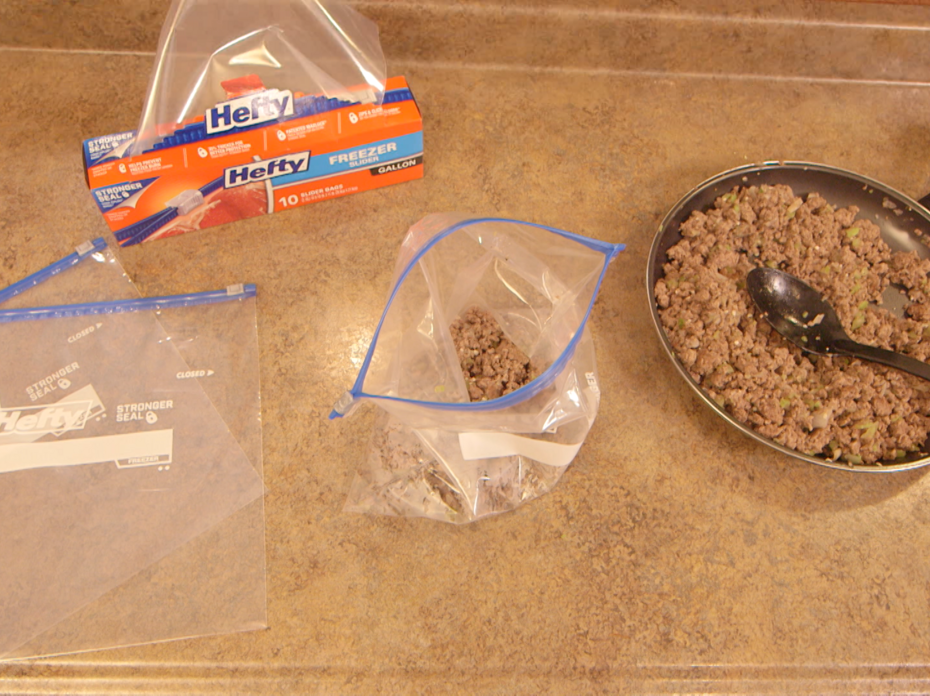 Browned ground beef, chopped onions, celery, and garlic in a non-stick skillet ready to spoon into individual freezer bags.