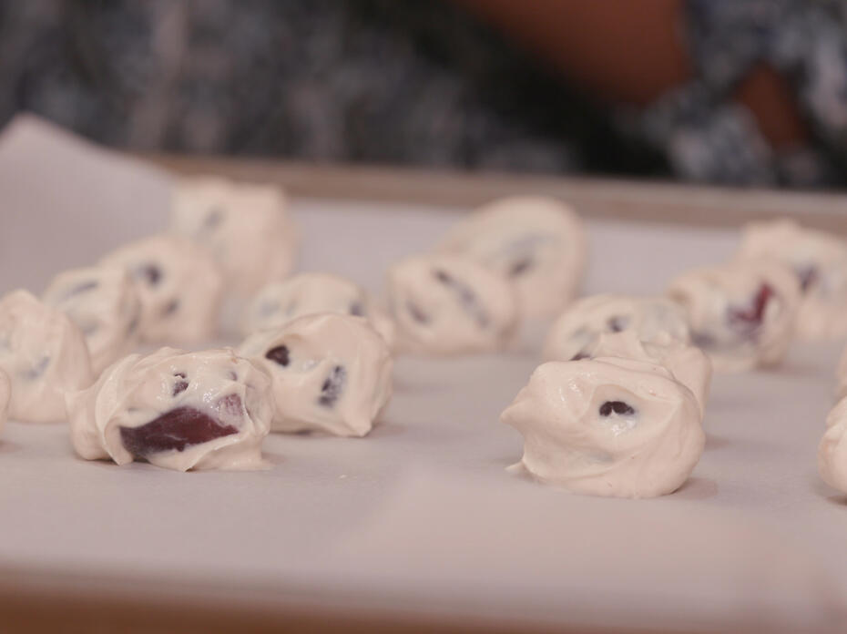Frozen yogurt-dipped grapes sit on a baking sheet.