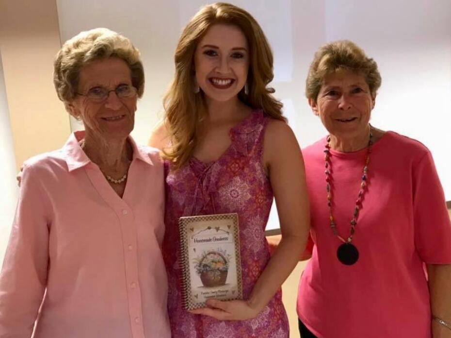 Two women who attended the Breast Cancer Awareness Luncheon pictured with speaker Molly May.  