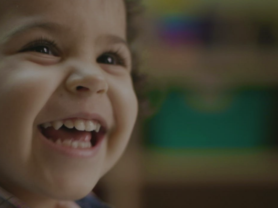 A baby smiling. 