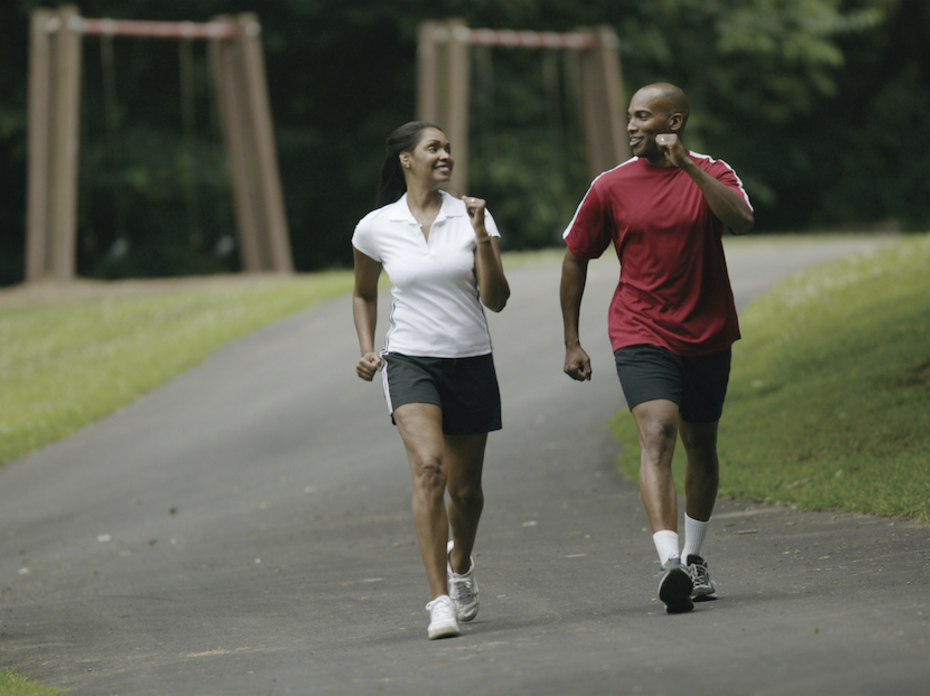 A woman and man walk for exercise.