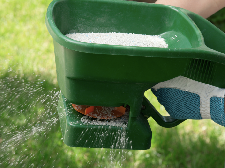 A person using a green manual fertilizer.