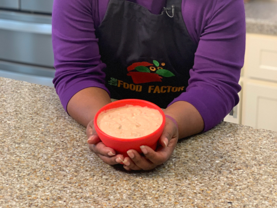 A woman stands in a kitchen.