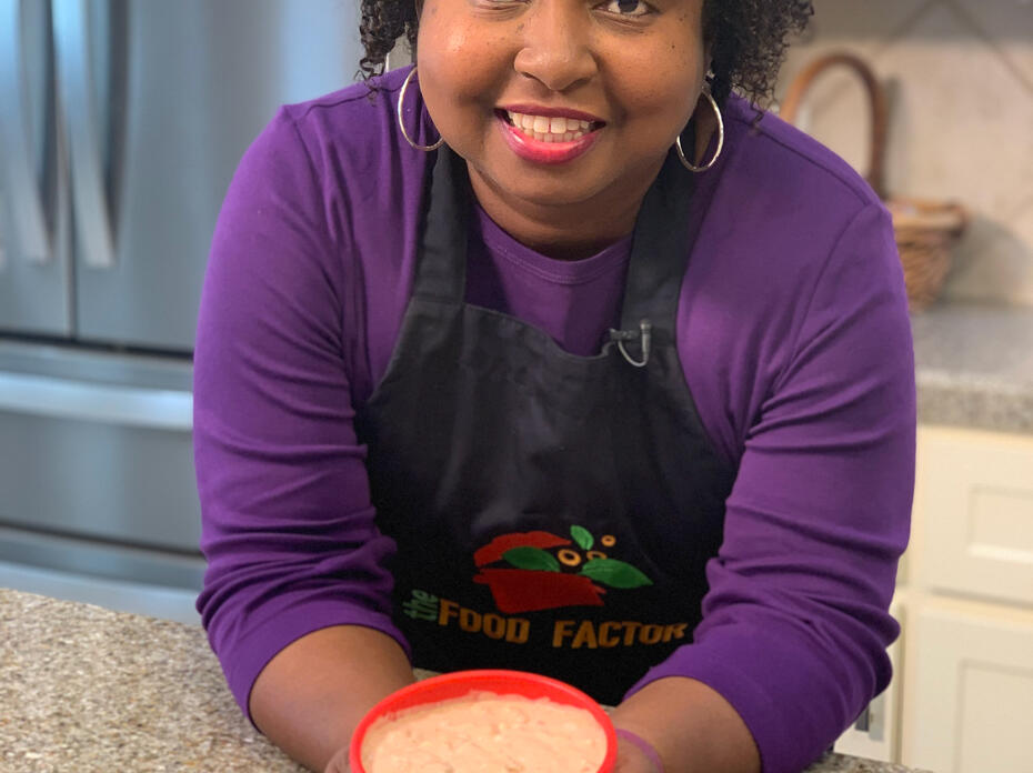 A woman stands in a kitchen.
