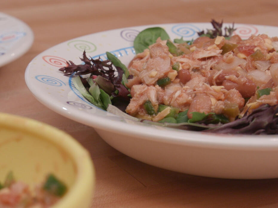 Spicy tuna on top of mixed greens, in a bowl as a dip, and in a wrap on a plate.