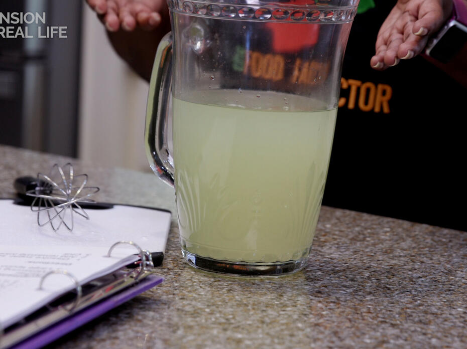A pitcher of homemade sports drink on a counter