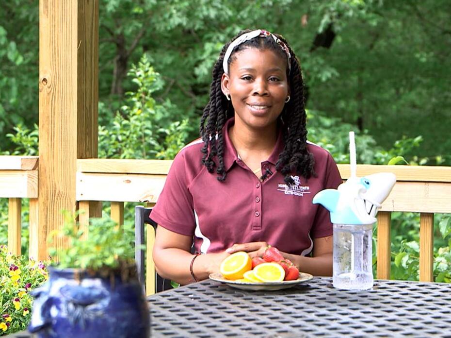 Woman smiling at a table.